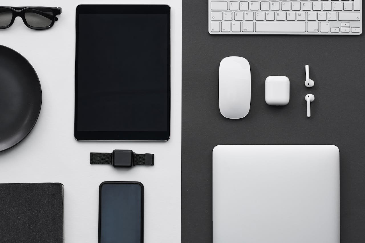 services-01 Stylish flatlay of modern tech gadgets including tablet, smartphone, smartwatch, and accessories.